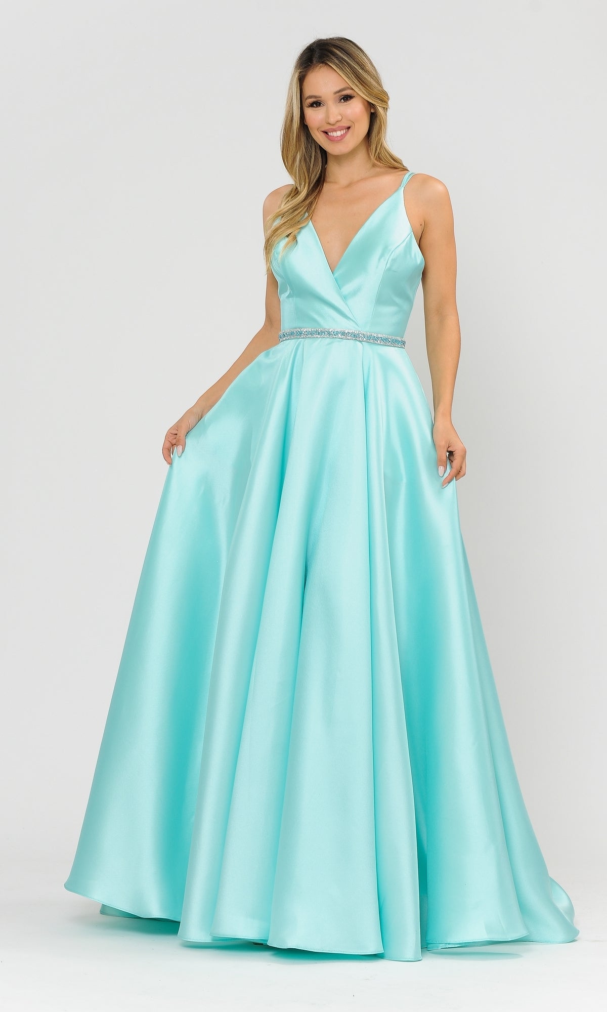 A woman models the Long A-Line Mikado Prom Gown 8690 in mint, featuring a sleeveless, floor-length design with a deep V-neckline, jeweled waistband, and pockets, posed against a plain white background.